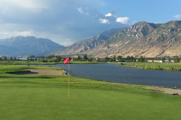 Green and Pin next to a river at the mountain's edge at East Bay Golf Course in Provo, Utah