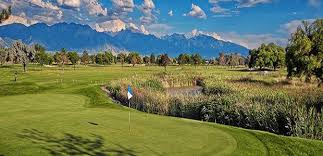 Pin on the putting green against the mountain backdrop at Glendale Golf Course in Salt Lake City, Utah