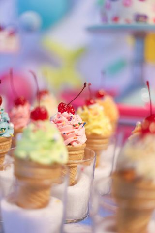 Soft serve ice cream in cake cones with cherries and toppings. Taken from ice cream shop in SLC!