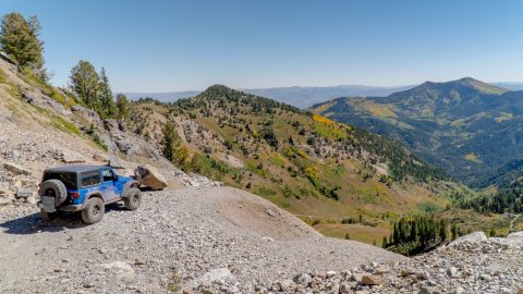 Jeep off-roading on a rocky trail in Mary Ellen Gulch, American Fork Canyon, Utah, with scenic mountain views.
