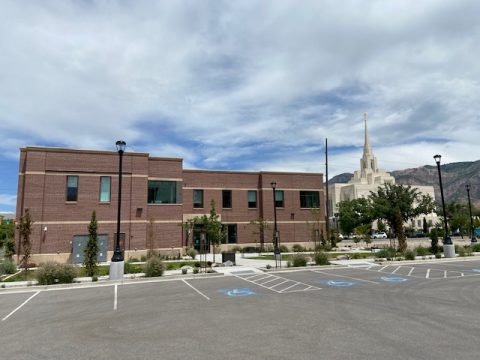 The Ogden Utah Family History Library is a red brick building located near the Ogden Utah Temple.