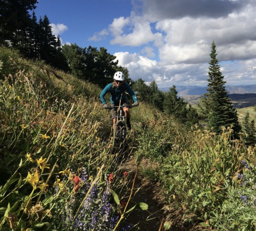 Woman enjoying single track mountain bike trail