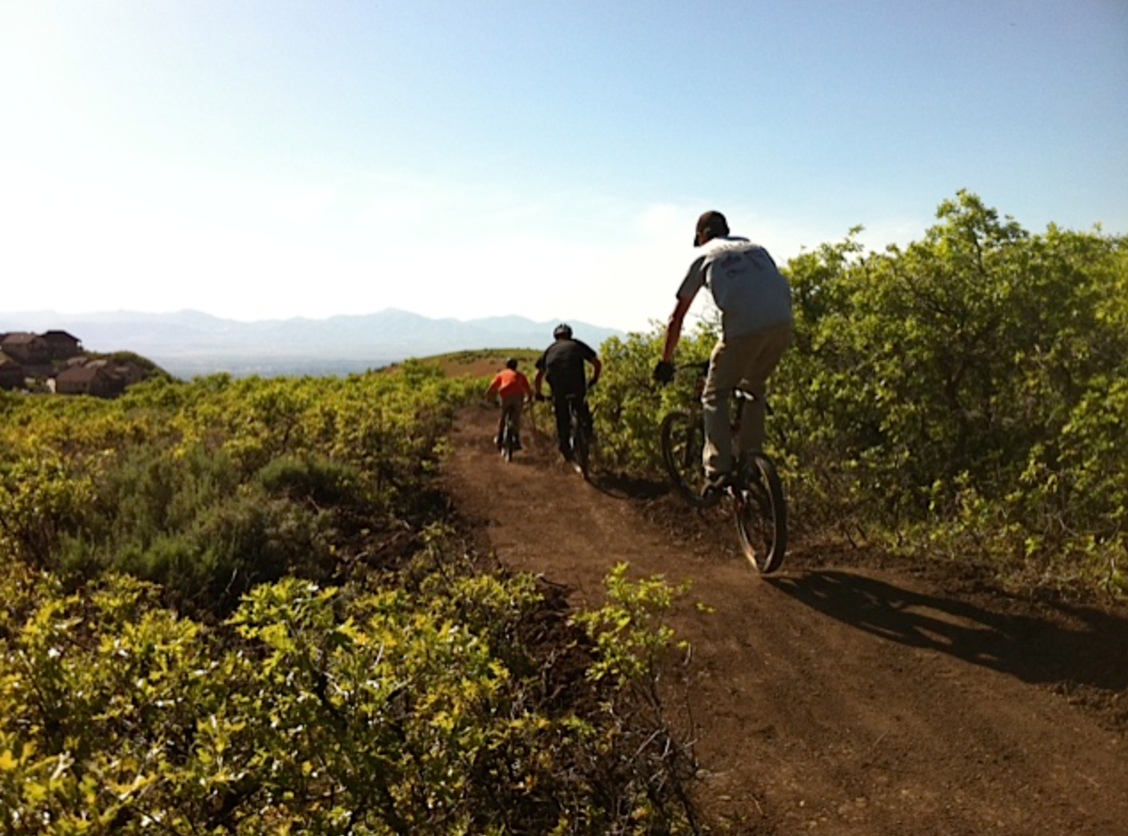 Group of mountain bikers riding down Corner Canyon trails (Draper, UT)
