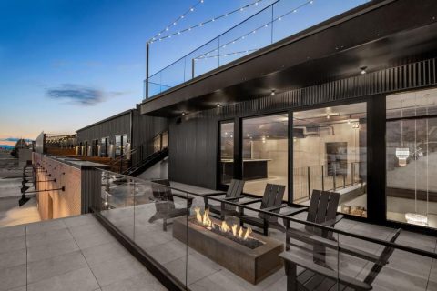 Evo Hotel rooftop patio in Salt Lake City with outdoor seating, fire pit, and modern hotel exterior