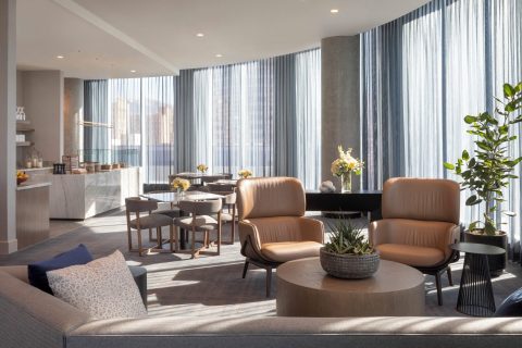 Hyatt Regency Salt Lake City hotel suite living room with sectional sofa, lounge chairs, coffee table, and modern decor in one of the top Salt Lake City hotels