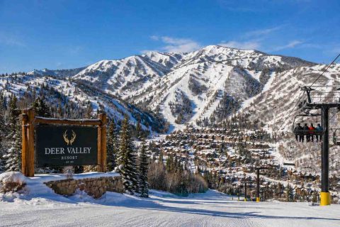 Snow-covered ski runs and chairlifts above a mountain village at Deer Valley Resort, Utah.